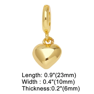 Close-up of gold heart charm with 23mm length and 10mm width dimensions on white background