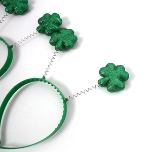 Macro detail of St. Patrick's Day headband with green glitter shamrock on silver spring