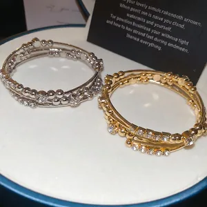 Multi-layer geometric open cuff bracelet with sparkling zircons in gold and silver finish