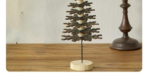 Macro detail of Nordic wooden snowflake Christmas tree with vintage beads and base