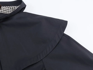 Detail of navy blue windbreaker with classic black and white gingham cotton lining
