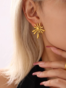 Detail of 18K gold stainless steel sunflower earrings on model showing sunburst design