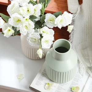 Minimalist vertical ribbed ceramic vases in beige and light green for home decor