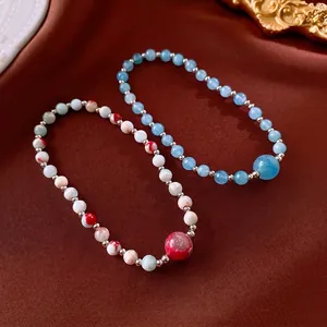 Elegant beaded Shoushan stone bracelets set with silver accents on velvet background