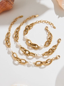 Detail of 18K gold-plated stainless steel chunky link chains with baroque pearls and lobster clasp