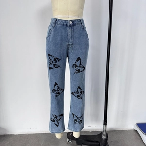 Detailed view of women's straight denim jeans featuring unique black butterfly prints