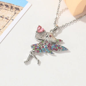 Silver fairy necklace with colorful rhinestones and a pink heart gem on white background