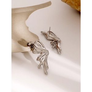 Close-up of gothic silver butterfly stud earrings with irregular fluid metal texture