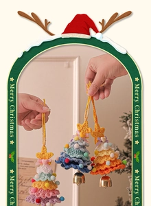 Handmade crochet Christmas tree charms with colorful pom poms and golden bells