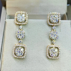 Macro shot of luxury gold bridal drop earrings with sparkling cubic zirconia pave setting