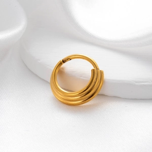 Macro shot of three-layer gold seamless ring jewelry on elegant white silk background