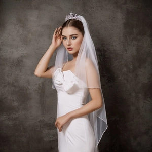 Close-up of white bridal veil with delicate handmade beaded edges and crystals