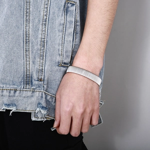 Close-up of a men's silver punk snakehead bracelet with vertical ribbed metal texture