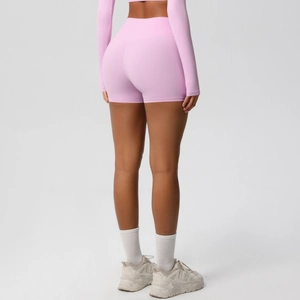 Macro detail of high-waisted peach yoga shorts showing back seam and lifting fabric