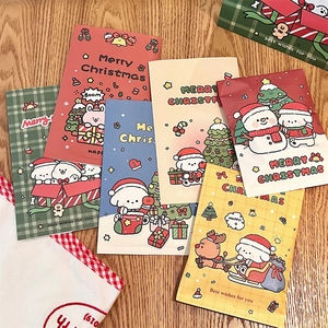 Detailed view of assorted Christmas gift bags with cute cartoon motifs on wood surface