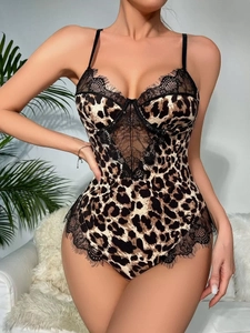 Detail of leopard print bodysuit featuring eyelash lace trim and V-shaped mesh cutouts