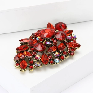 Macro shot of vintage alloy brooch with red faceted glass crystals and rhinestones