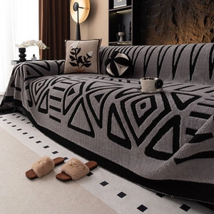 Detail of plush geometric pattern sofa cover in black and gray thick flannel fabric