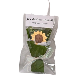 Handmade crochet sunflower bouquet in green gift wrapping with decorative ribbon and card