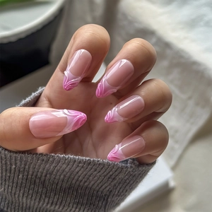 Macro view of 3D embossed almond press-on nails with pink gradient mermaid tail texture
