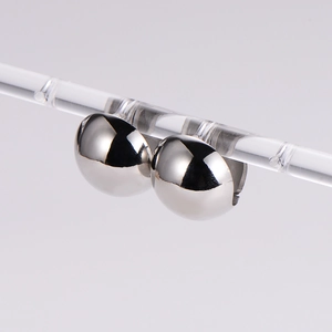 Minimalist silver spherical stud earrings with a high-polished mirror finish in a pair