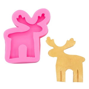 Detail showing a pink silicone elk mold beside a finished golden 3D reindeer figure