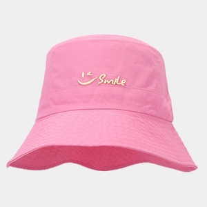Detail of pink quick-dry sun hat showing mesh fabric and yellow Smile logo print