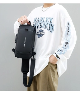 Detail of waterproof black crossbody bag featuring a secure combination lock and fashion text