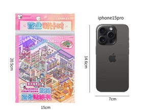 Size comparison of 20.5x15cm PET sticker book for scrapbooking beside iPhone 15 Pro