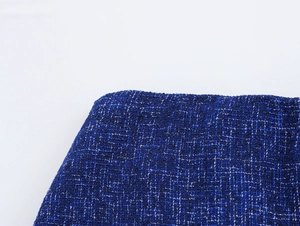 Close-up of deep blue tweed fabric texture with black and white woven details