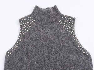 Close-up of grey mohair blend knitwear featuring silver rhinestone beading on shoulders