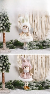 Detail of plush angel ornaments with rabbit ears and wings for Christmas tree decor