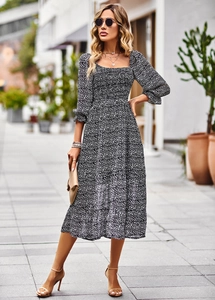 Detail view of square neck floral dress featuring three-quarter sleeves and pleated waistline