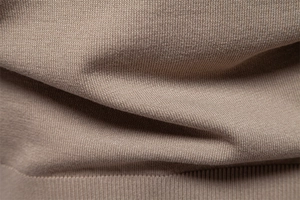 Close-up of the taupe knit fabric showing the detailed texture and premium soft material