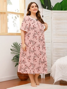 Detailed close-up of lace neckline and black bow on a floral print pink nightdress