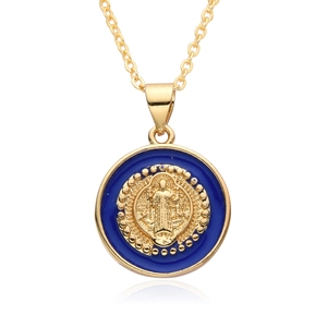 Close-up of golden religious Virgin Mary pendant with dark blue enamel detail