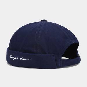 Detail of navy blue Miki hat with white Carpe diem embroidery and adjustable strap back
