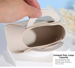 Detailed view of an empty beige mini leather-textured gift box with a curved handle