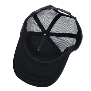 Detail view of the breathable black mesh trucker hat lining and adjustable plastic snap