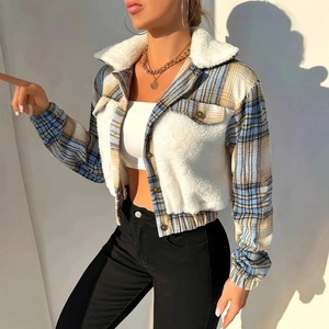 Detail of blue and yellow plaid texture with soft white faux fur collar on a jacket