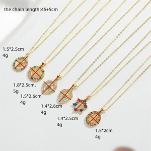 Gold plated zircon necklaces with Virgin Mary and heart pendants on white silk