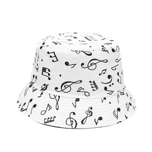 Reversible bucket hat with black music note patterns on white cotton fabric