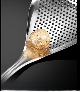 Macro shot of mirror-polished stainless steel skimmer spoon with fine drainage holes