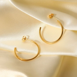 Chic 18K gold plated stainless steel C-shaped stud earrings on beige silk fabric