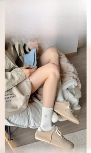 Detail of light blue ribbed and cream star pattern combed cotton crew socks for women
