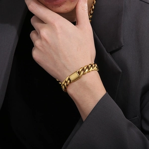 Close-up of 12mm gold Cuban link bracelet on a wrist with a polished box clasp