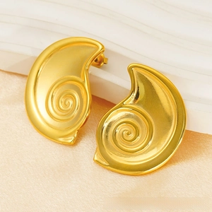 Macro view of gold 18K plated stainless steel stud earrings with spiral snail shell texture