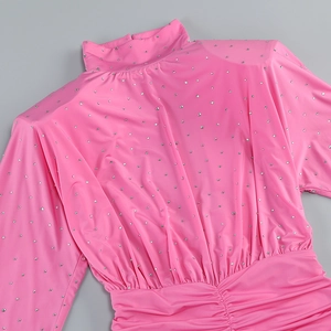 Detail view of pink turtleneck dress with sparkling rhinestones and waist ruching design