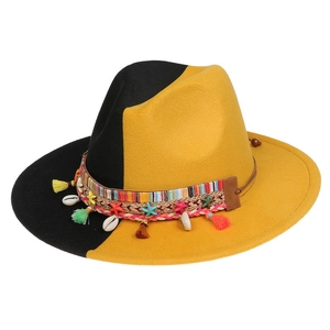Detail of wool jazz hat with ethnic decor, striped band, shells and tassels on brim
