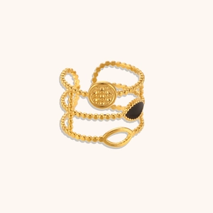 Close-up of 18K gold beaded triple-layer ring featuring a black enamel oval element